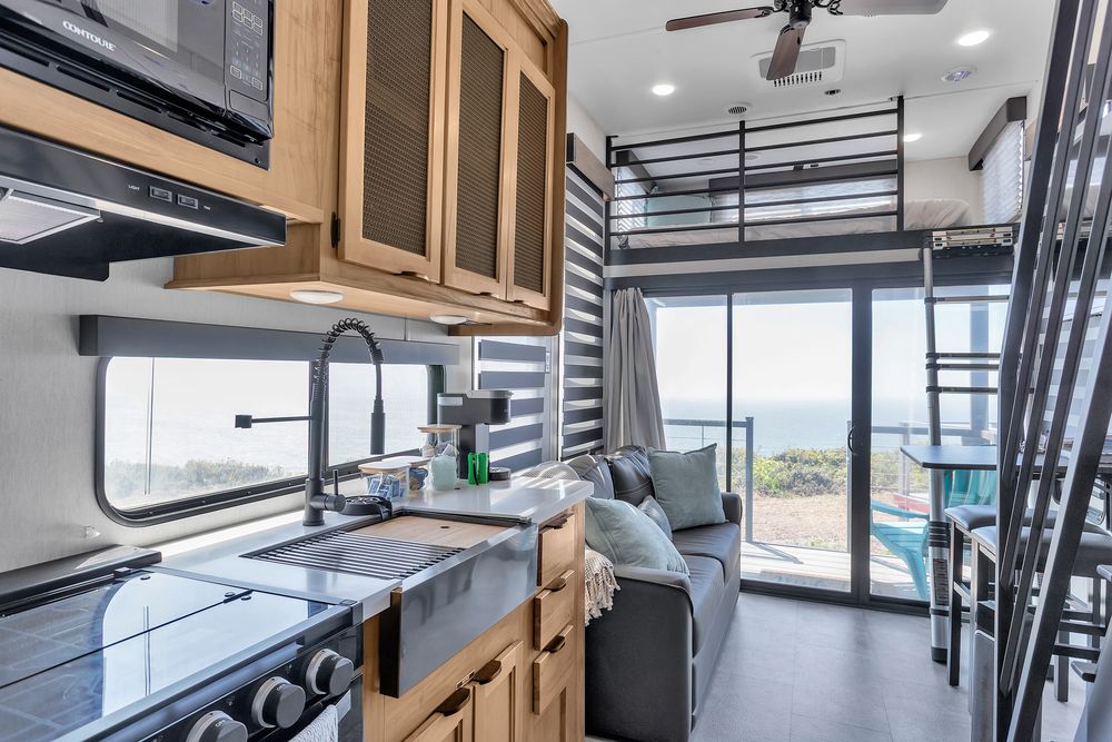 Kitchen and living area of the Large Trailer with the ocean through the glass doors