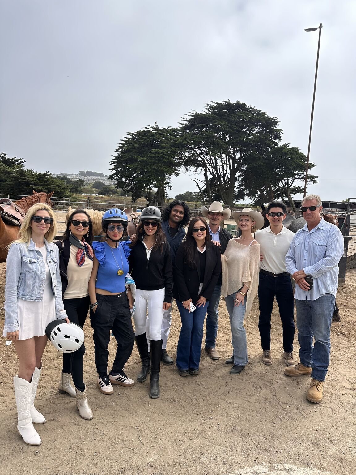 A corporate team together with the horses after a leadership session at Ocean View Stables