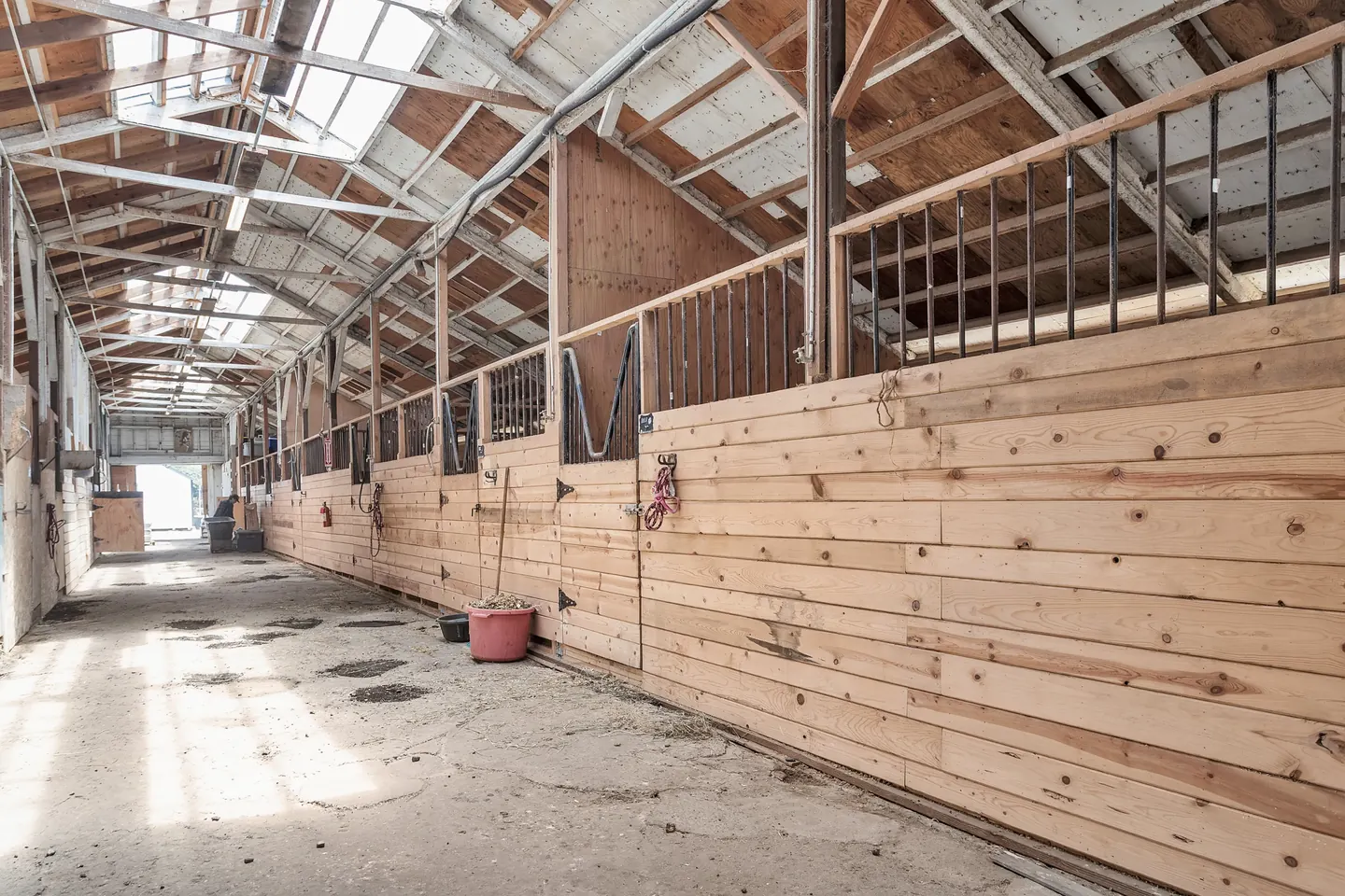 The wooden stall aisle inside the barn at Ocean View Stables in Daly City